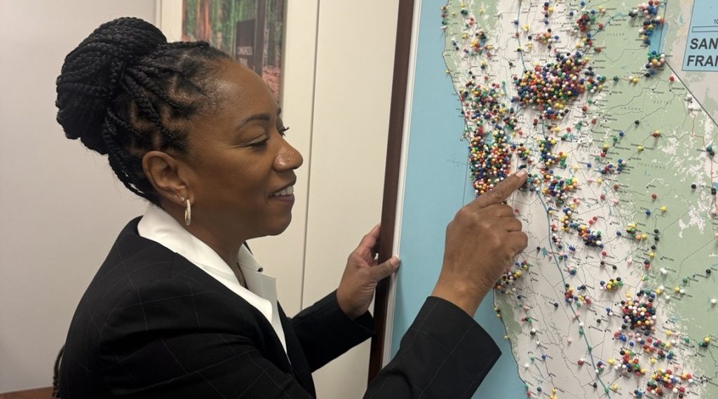 Ronna Green pointing to Mountain House on a map of California water projects