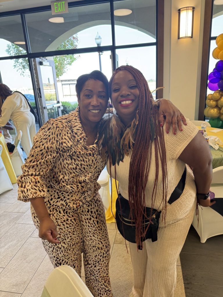 Ronna Green embracing a friend at a community event