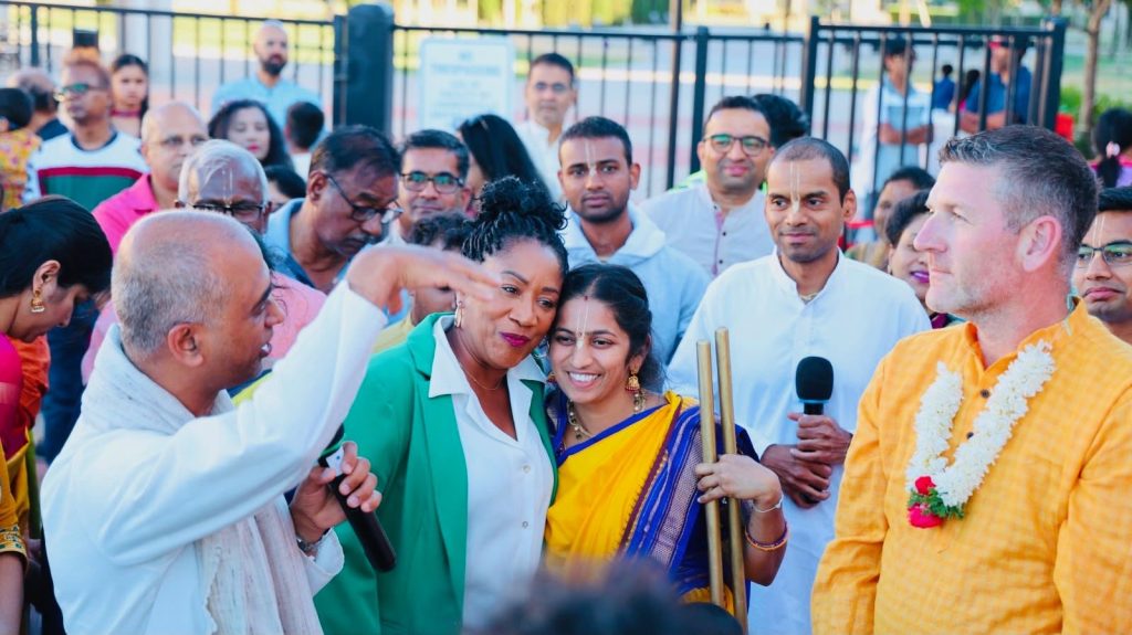 Ronna Green receiving a garland at a cultural celebration