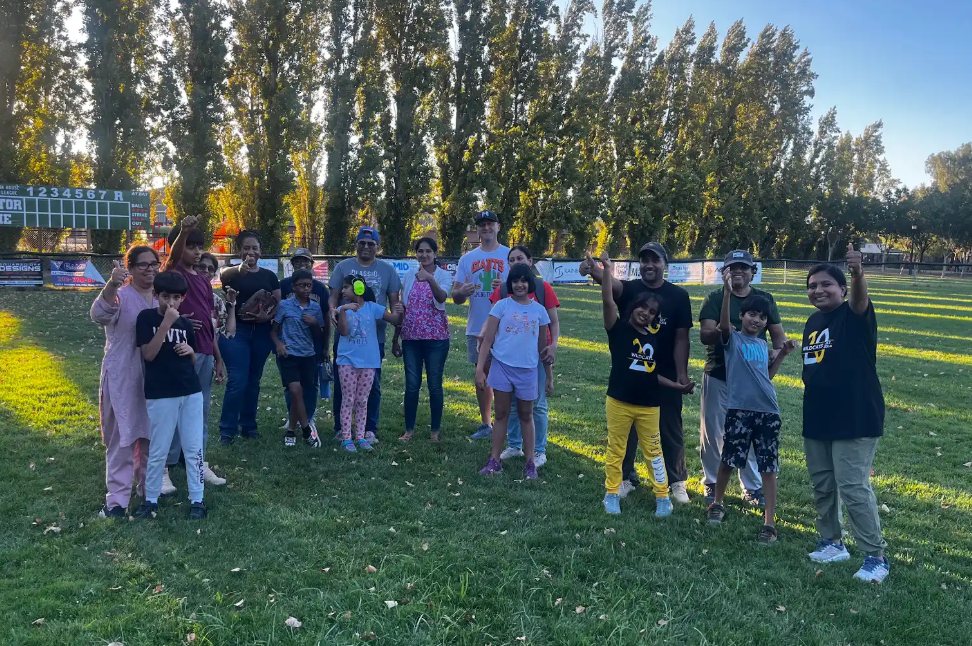 Children and families on a field at a community event