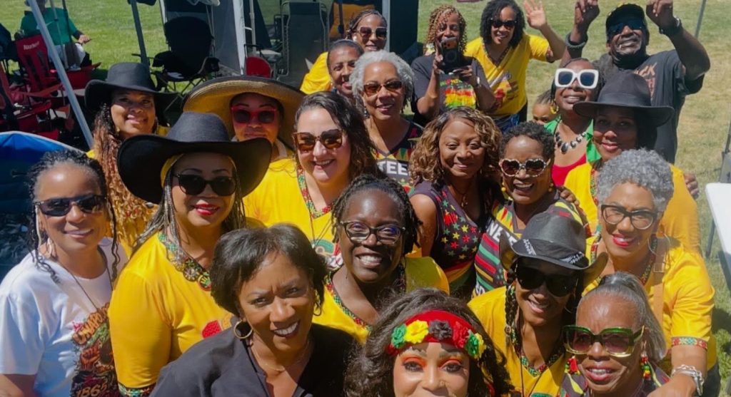 Ronna Green with a group of women dressed in yellow at a community celebration