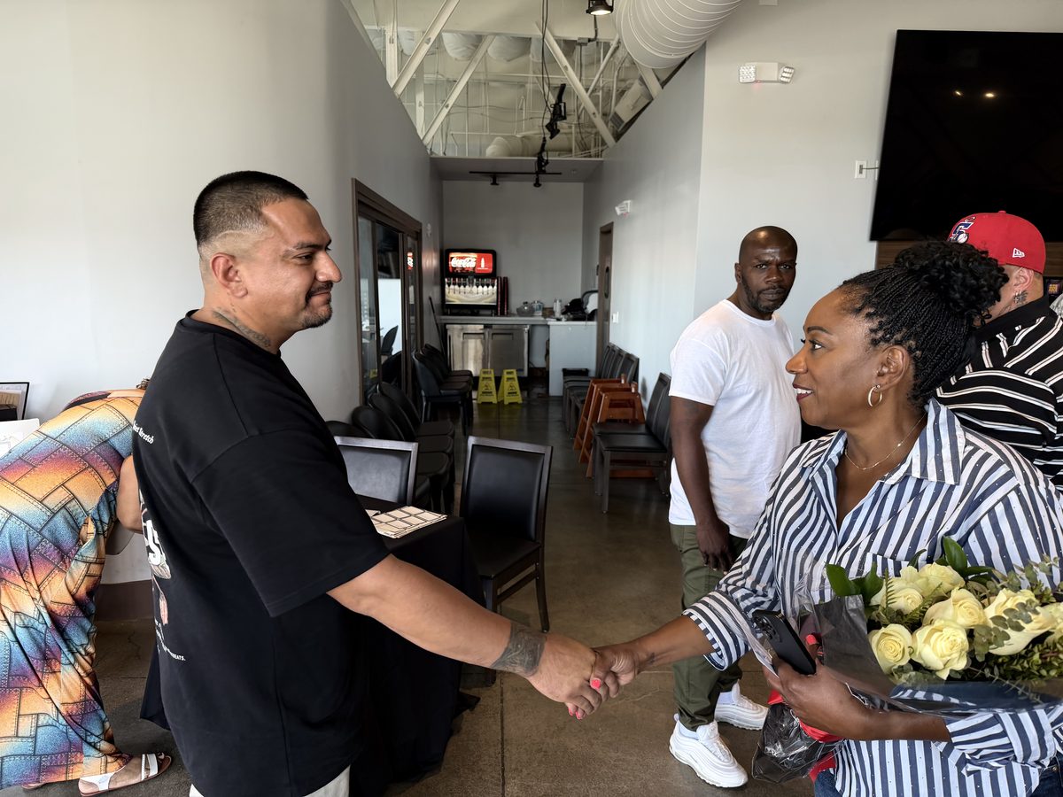 Ronna Green shaking hands with a supporter at a campaign event